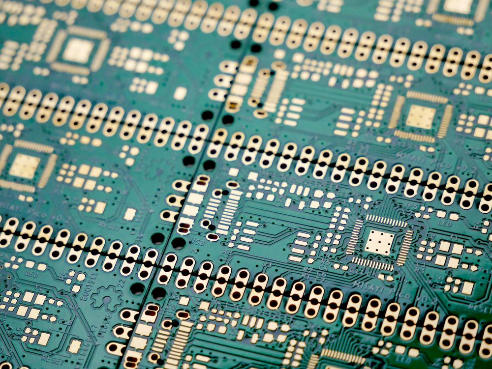 Close-up of a populated circuit board during inspection.