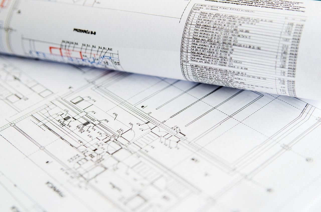 Rolled and flat technical drawings with an equipment schedule